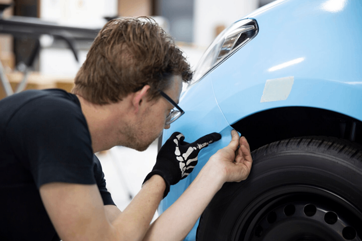A mechanic fixing damage on the car